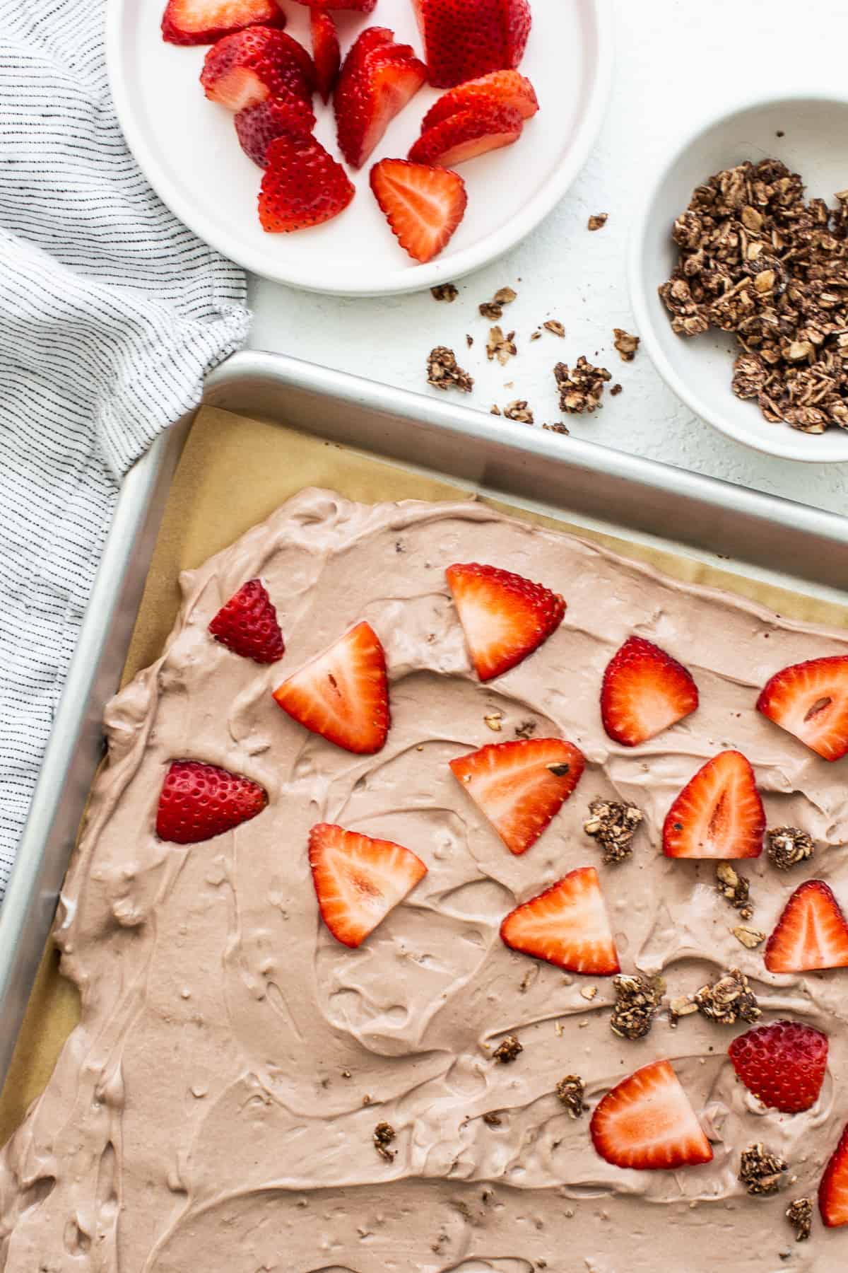 Frozen yogurt bark topped with strawberries.