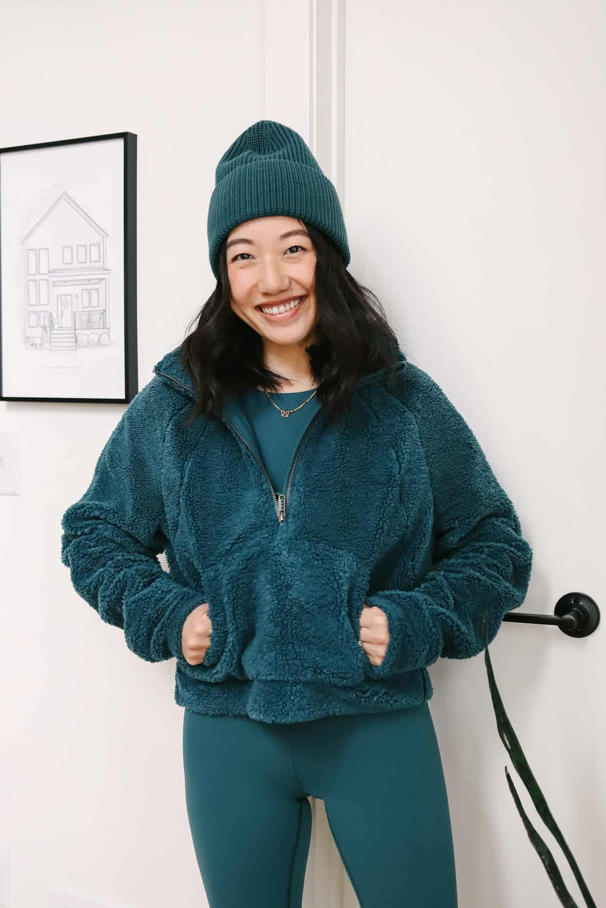 Woman wearing a cozy sherpa zip up.