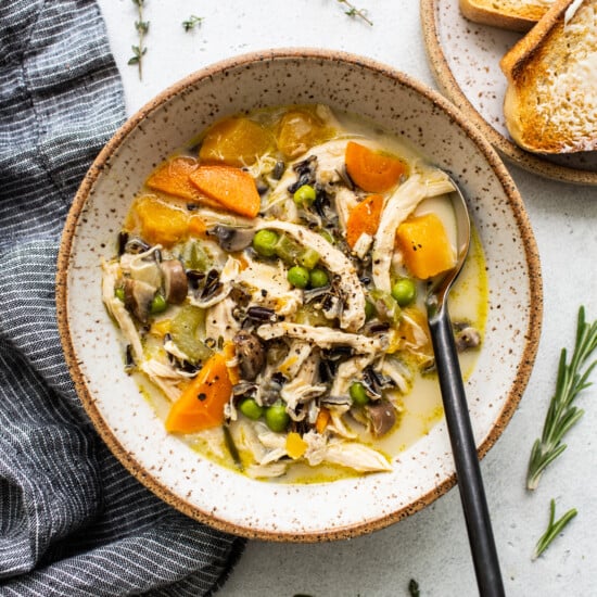 A bowl of turkey soup with wild rice and vegetables.