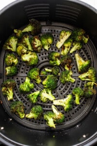 An air fryer filled with broccoli.