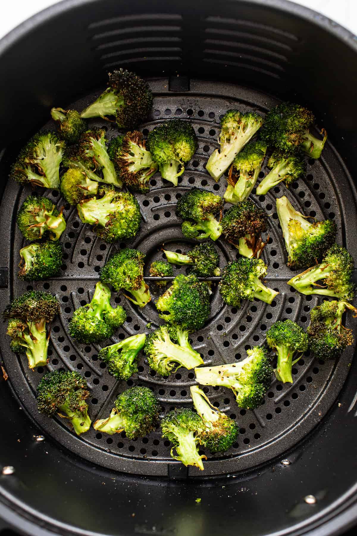 Crispy broccoli florets in an air fryer.
