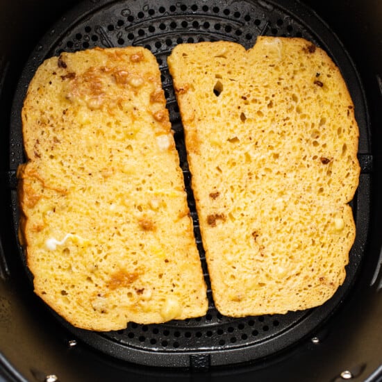 Two slices of bread in an air fryer.
