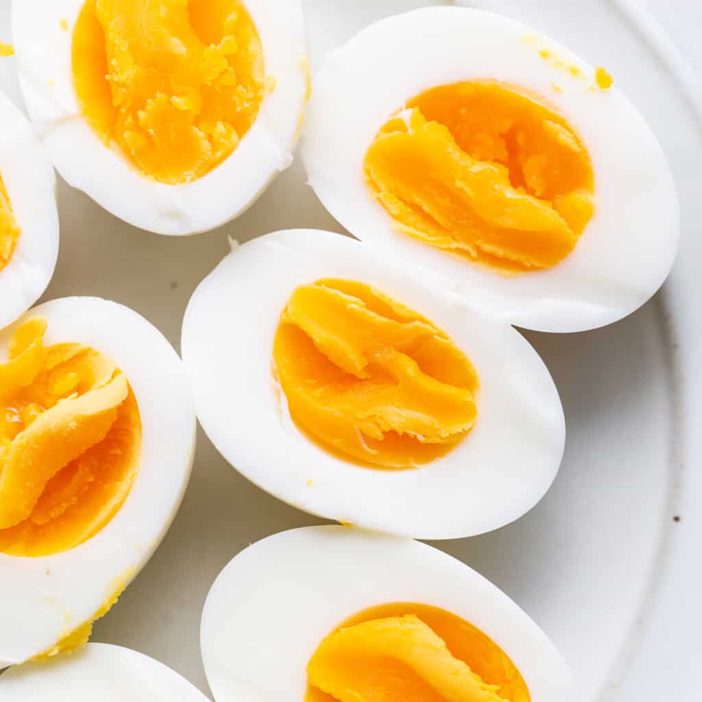 Hard boiled eggs connected  a plate.
