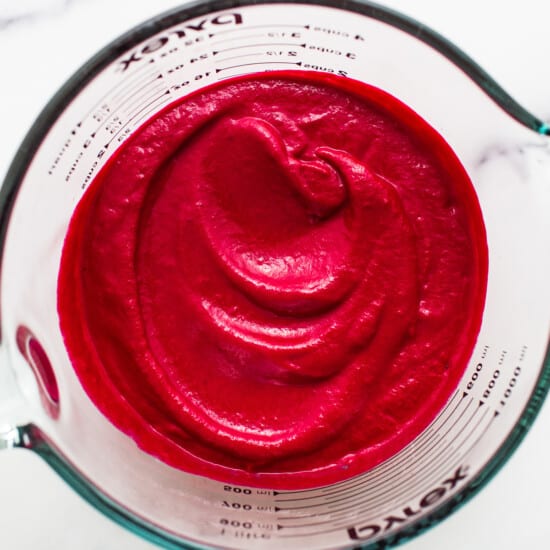 Beet puree in a measuring cup.