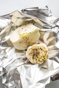 A piece of potato wrapped in foil with spices.