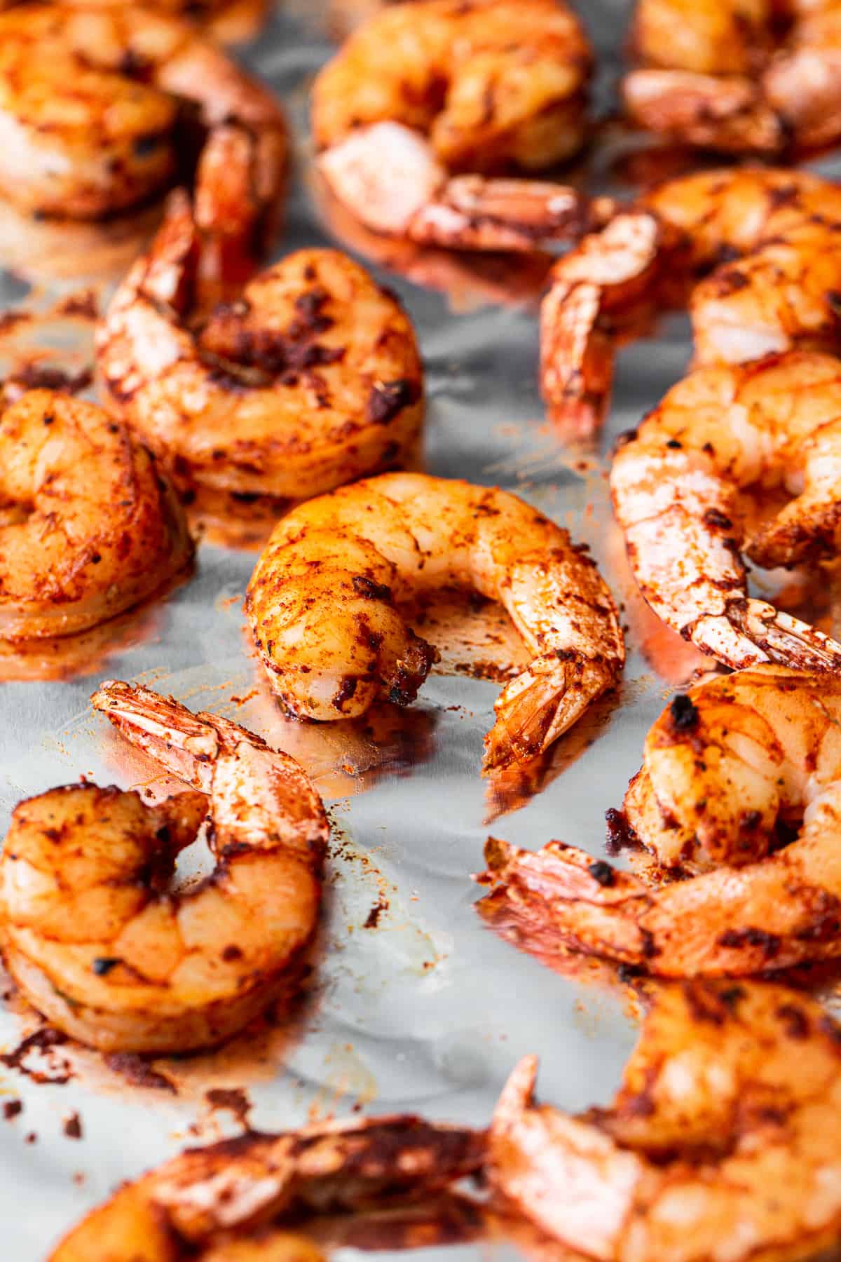 Broiled shrimp on a baking sheet.