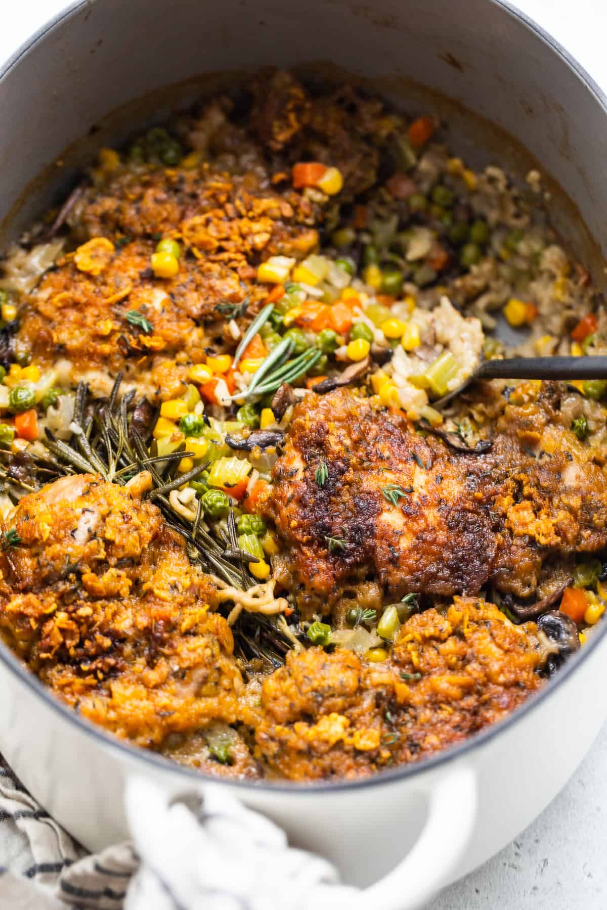 Chicken pot pie skillet being scooped out of a skillet with a spoon.