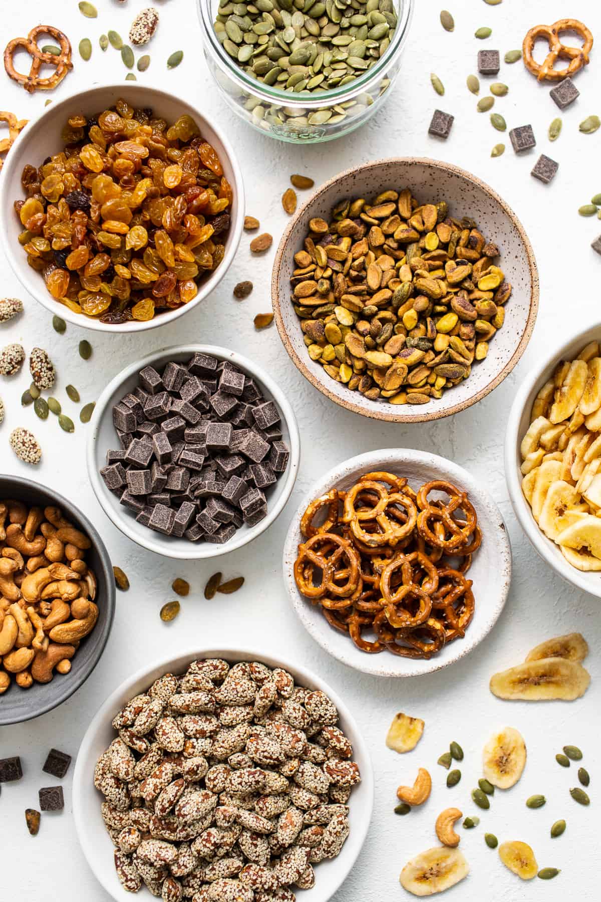Homemade trail mix ingredients in bowls.