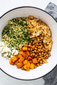 All of the ingredients for the couscous salad in a bowl.