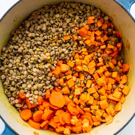 A pot filled with carrots and lentils.