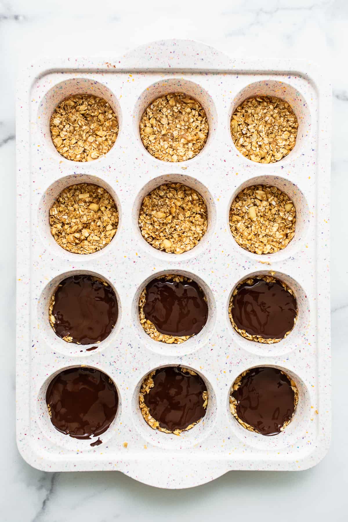 Peanut butter oat cups in a muffin tin.