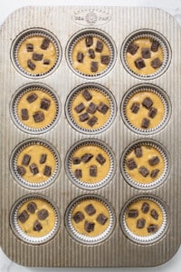 A muffin tin filled with chocolate chip muffins.