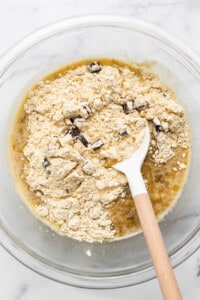 A bowl of ingredients with a wooden spoon in it.