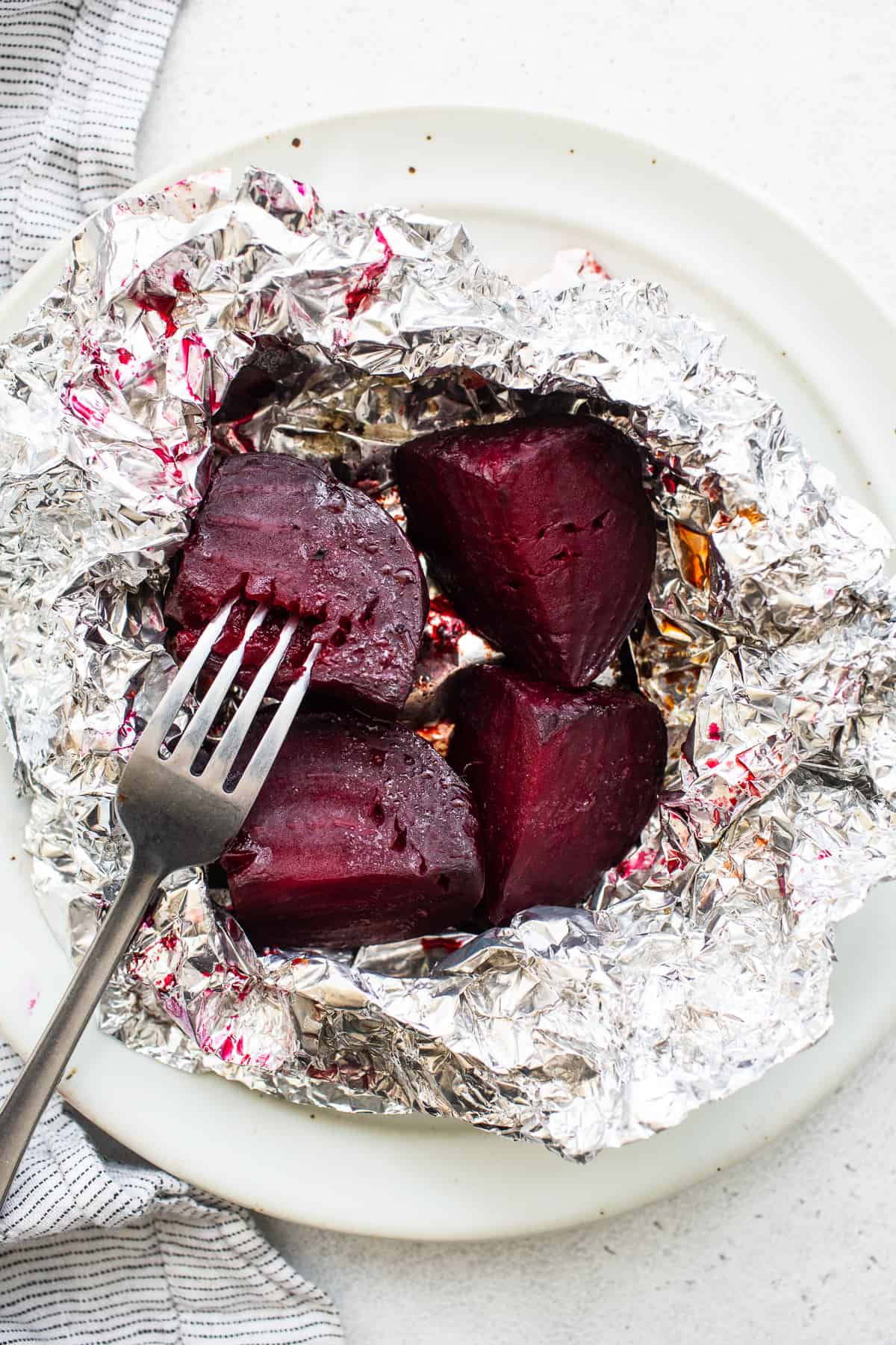 Roasted beets with a fork in them.