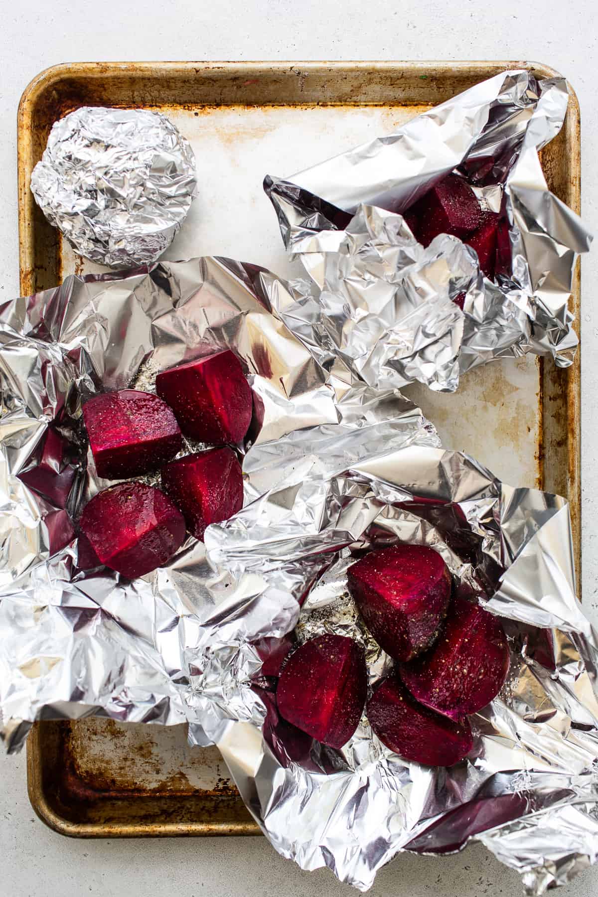 Sliced beets wrapped in tin foil.