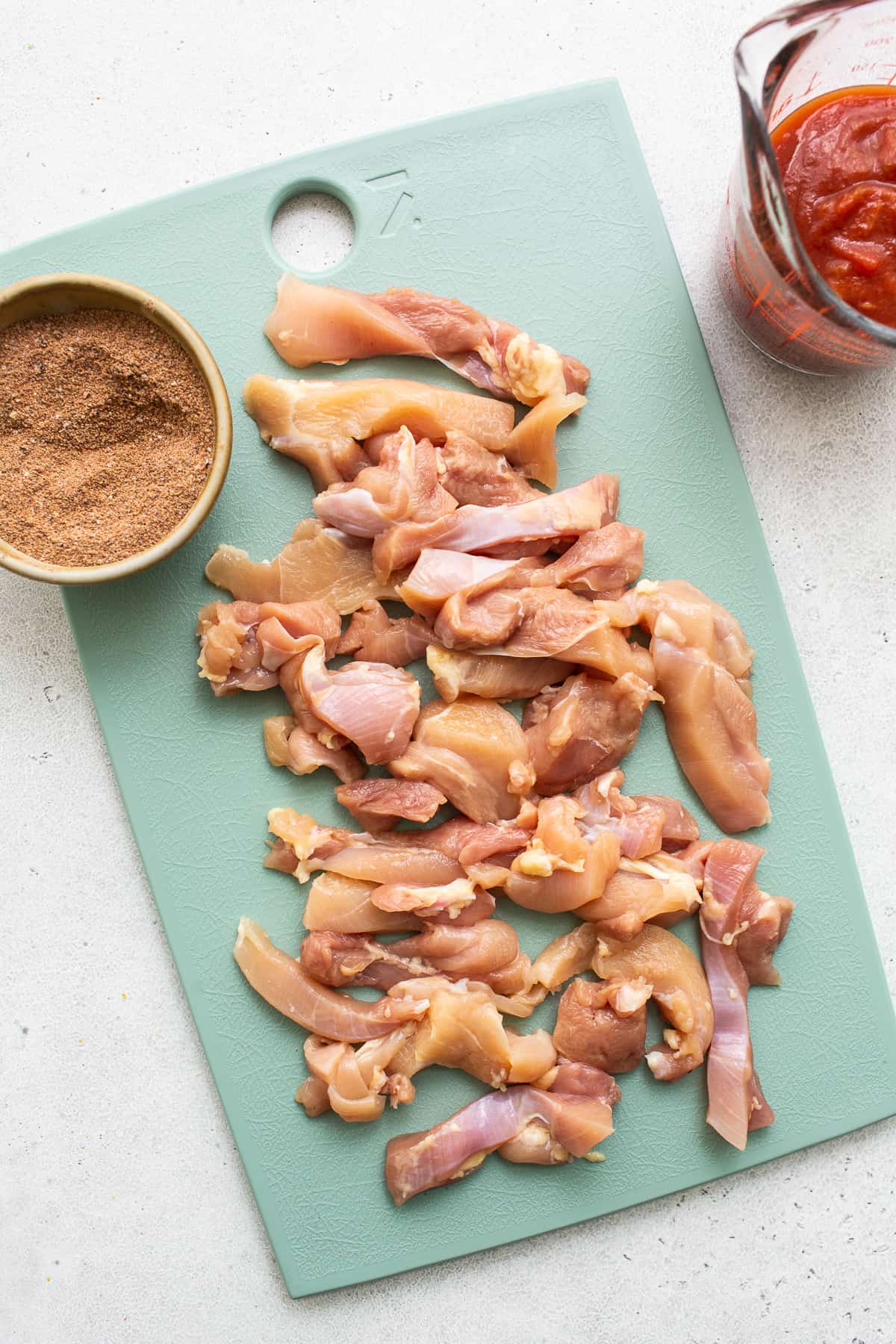 chicken thighs on cutting board.