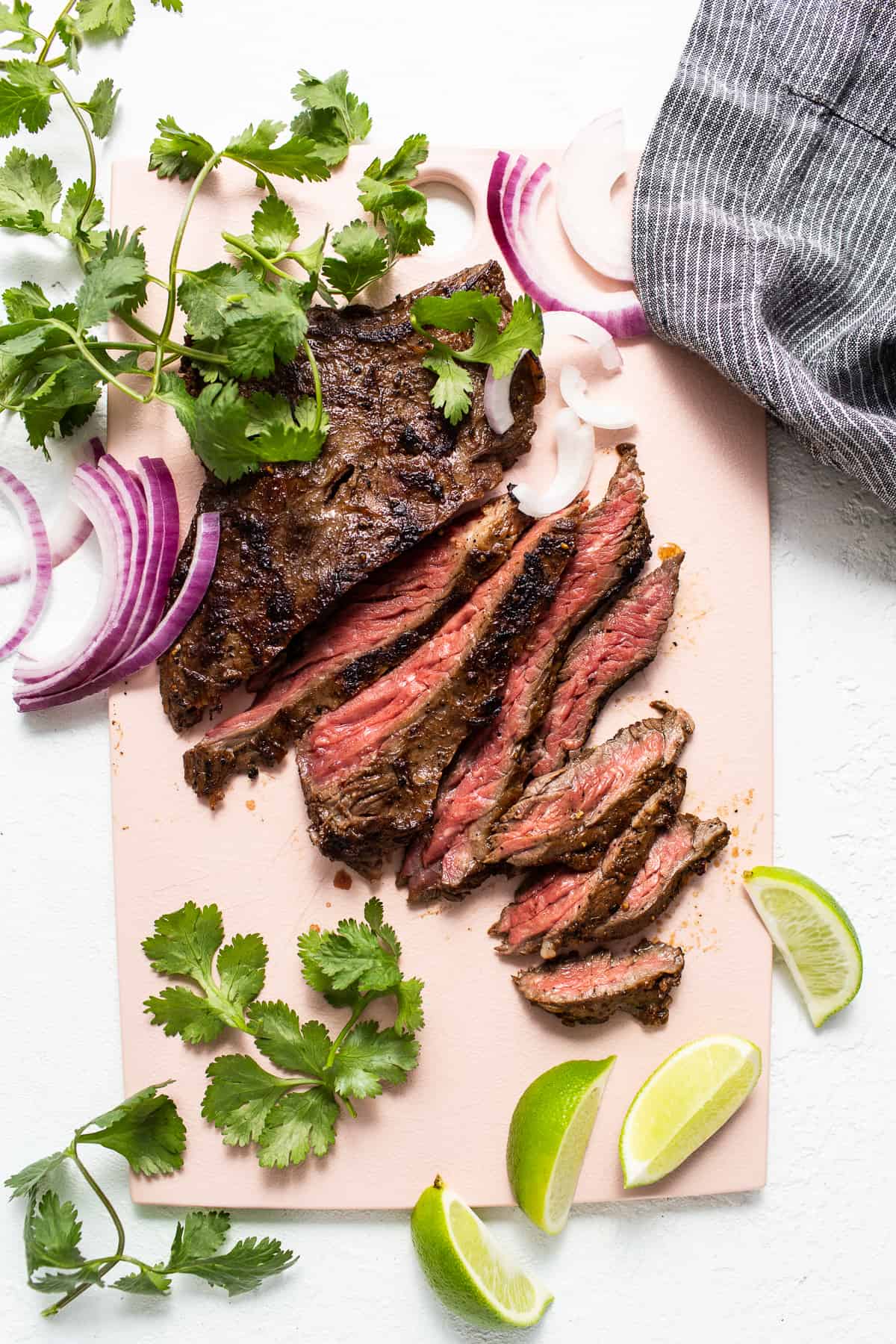 Sliced skirt steak on a cutting board.