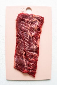 A piece of beef on a cutting board.