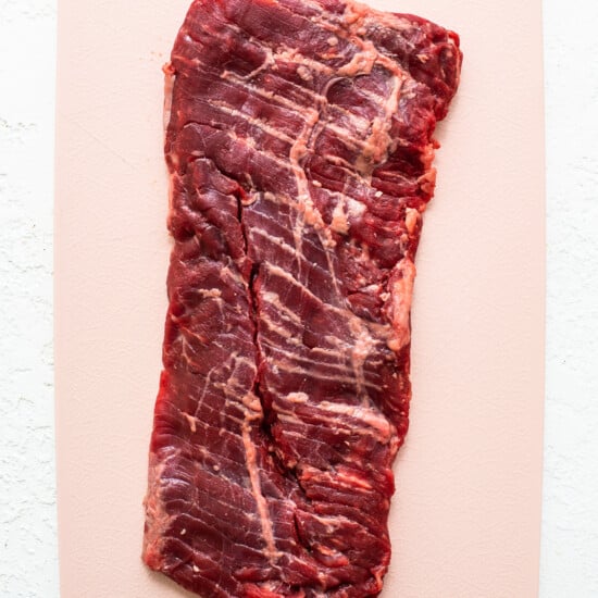 A piece of beef on a cutting board.