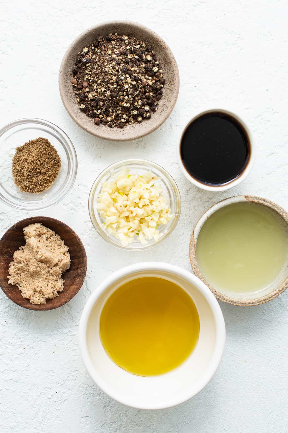 Ingredients for skirt steak marinade in small bowls. 