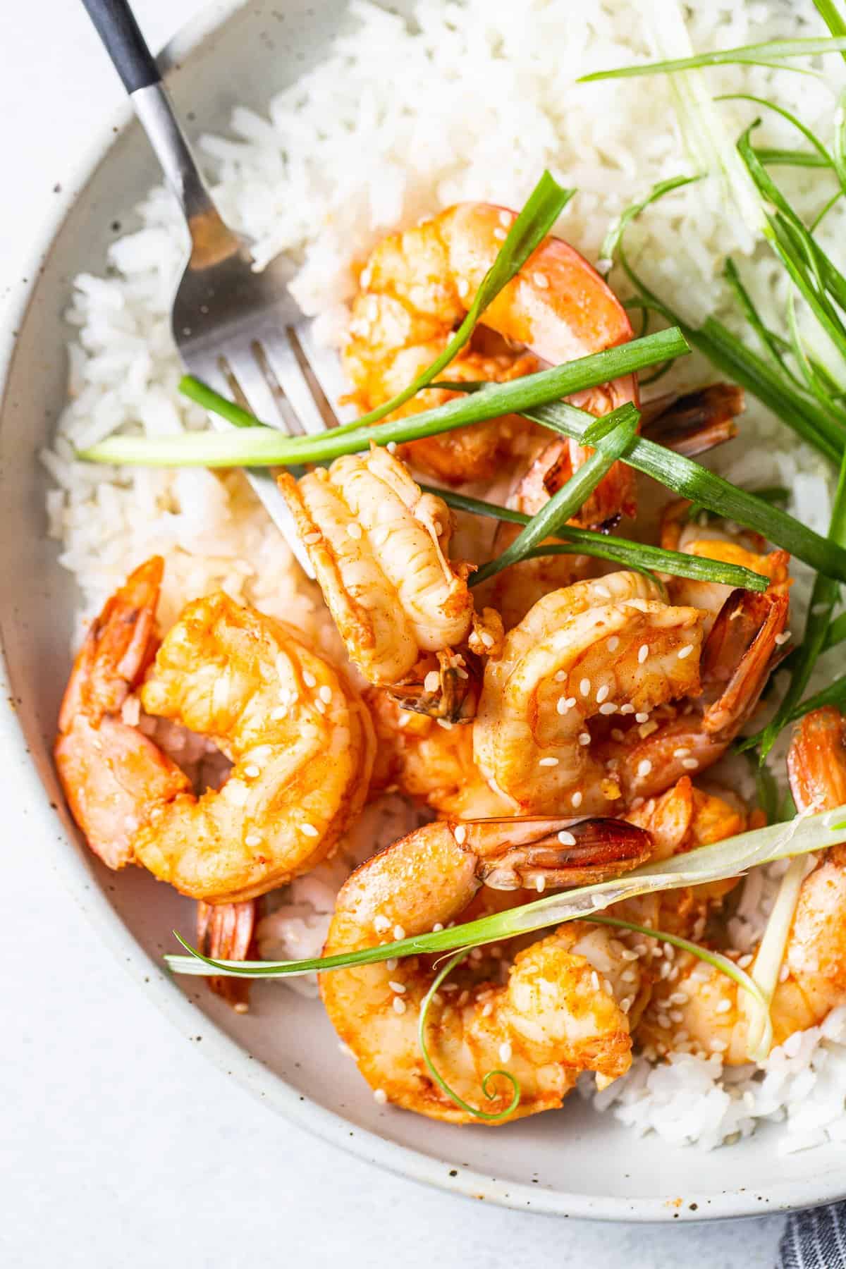 Spicy garlic shrimp in a bowl with rice.