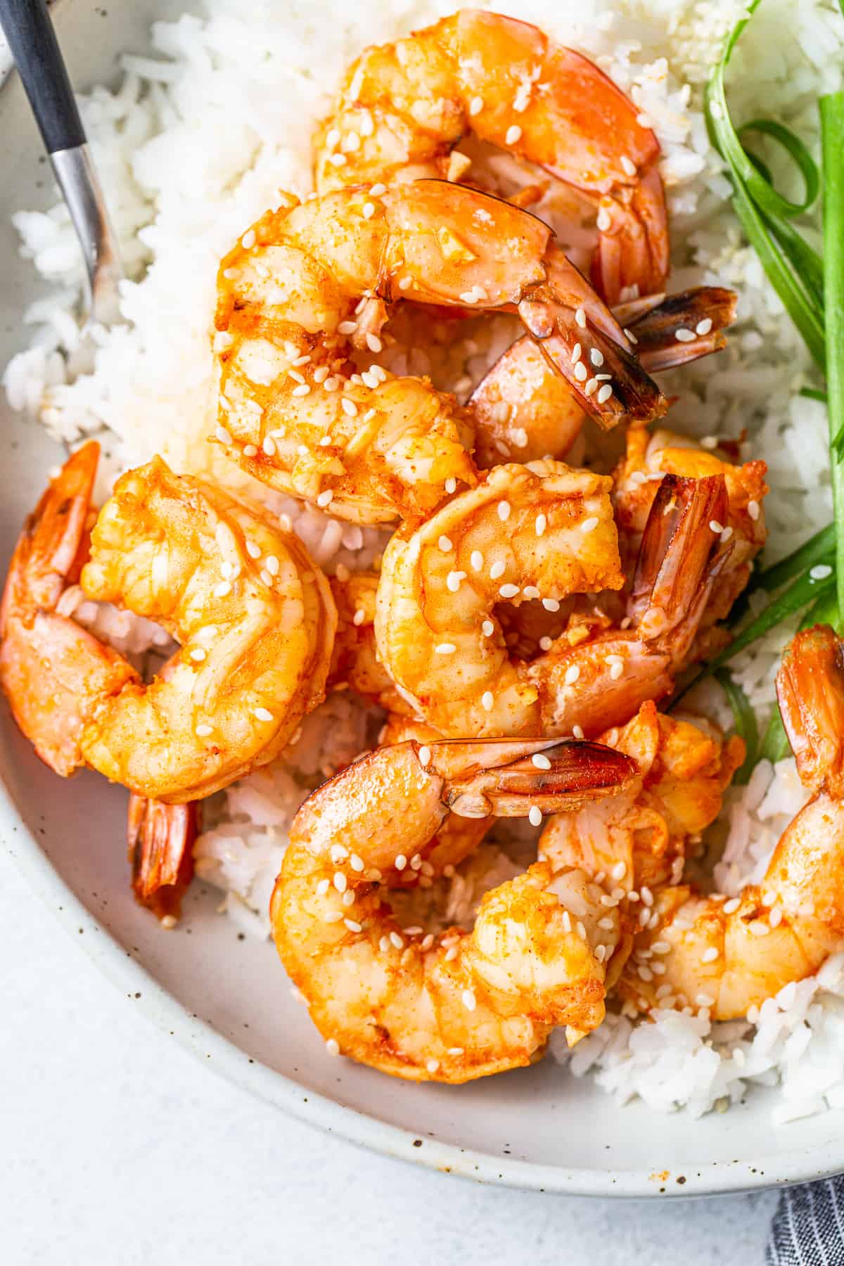 Spicy garlic prawns in a bowl with rice.