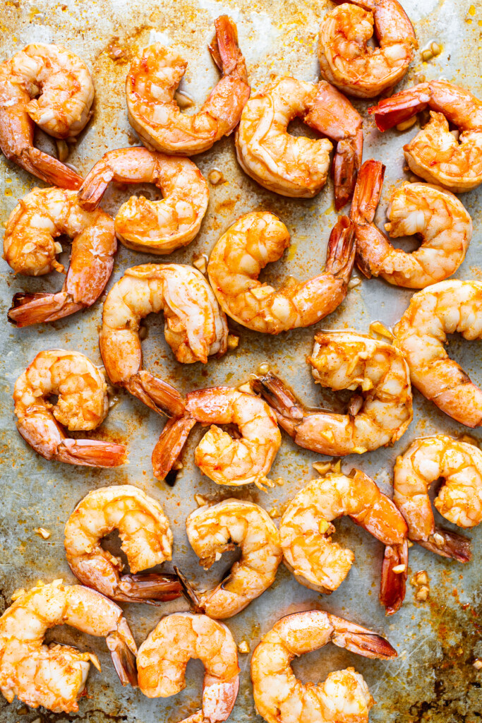 Spicy garlic prawns on a baking sheet.