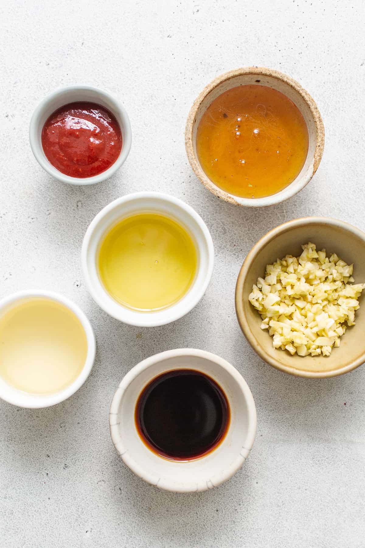 Ingredients for spicy garlic prawns sauce in bowls.