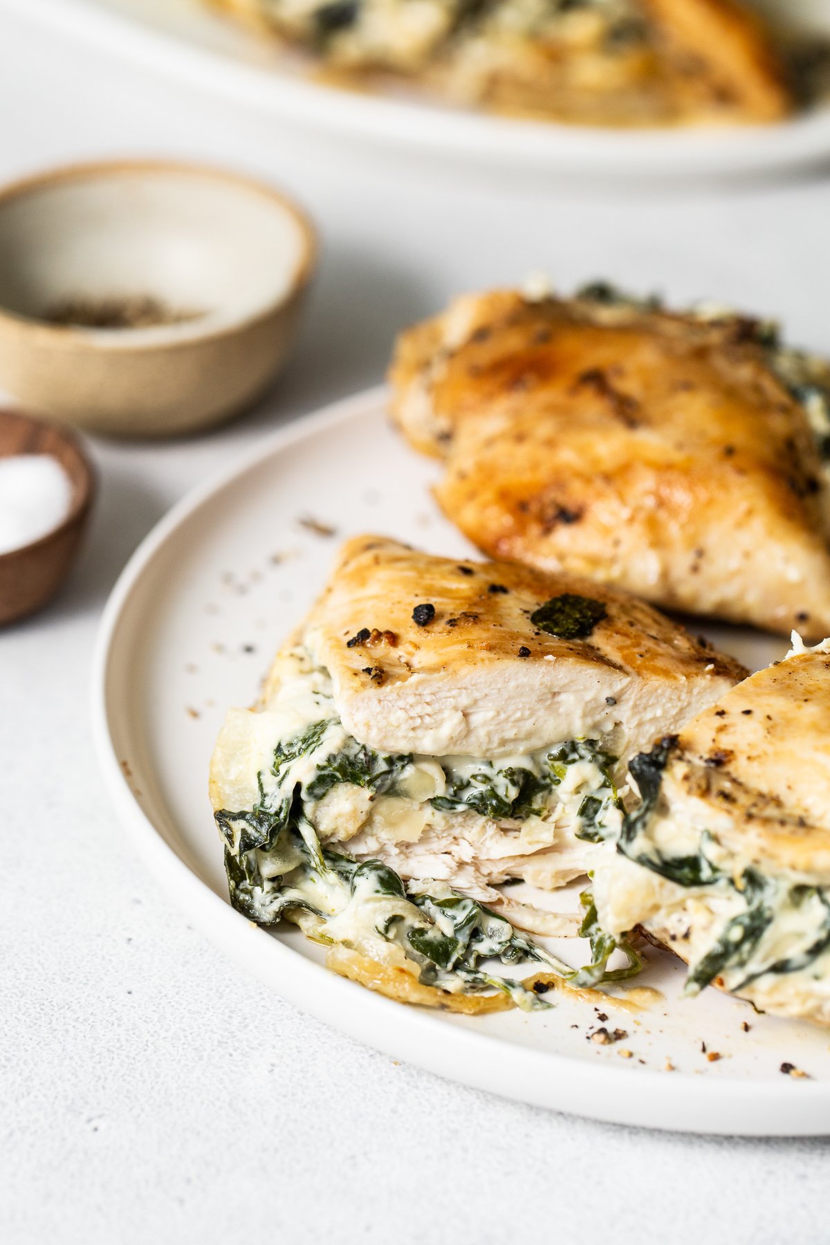 Spinach stuffed chicken breast on a plate.