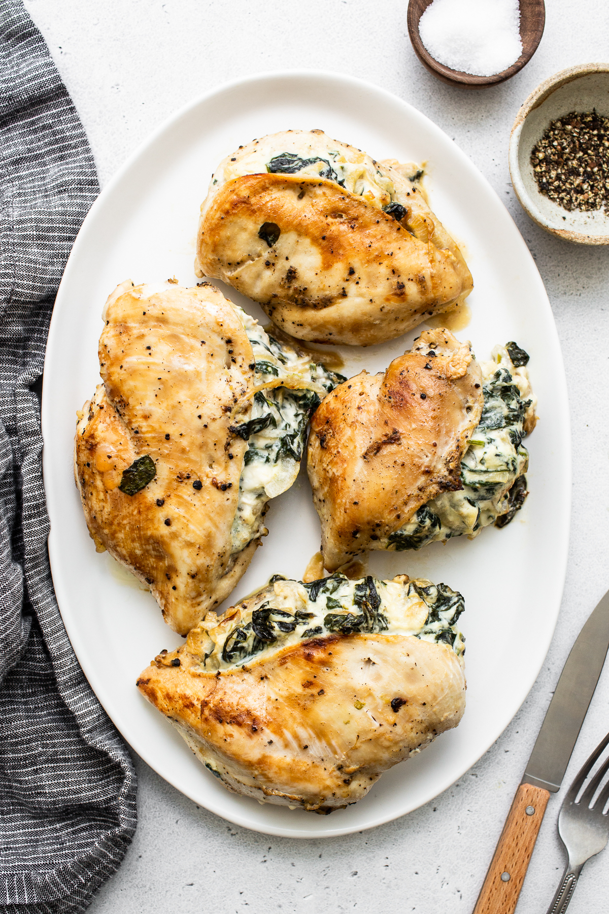 Spinach stuffed chicken breast on a plate.