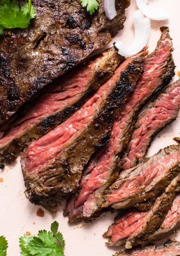 Slices of skirt steak on a cutting board.