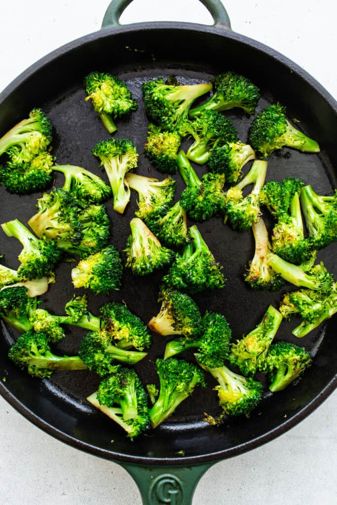 sauteed broccoli on cast iron pan.