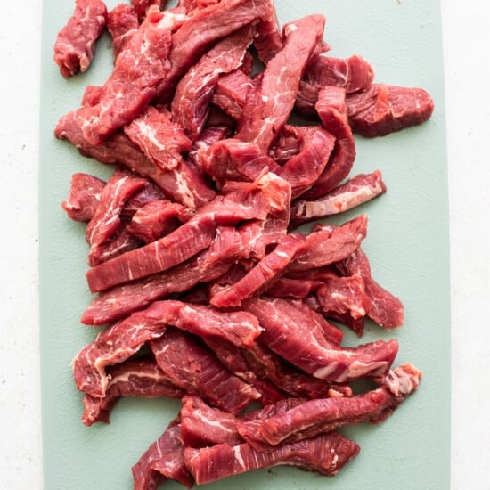 sliced beef on cutting board.