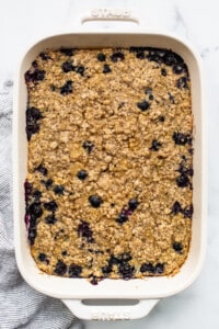 Blueberry oatmeal in a white baking dish.