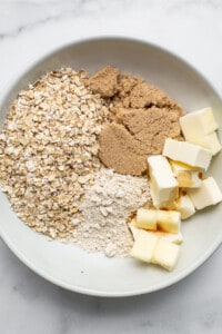 Oats, butter, sugar and cinnamon in a bowl.