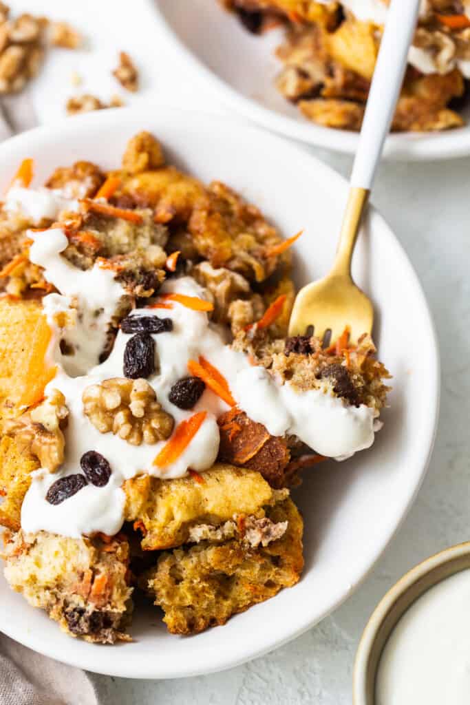 Carrot cake french toast casserole on a plate with a fork.
