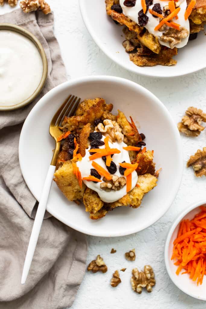 Carrot cake french toast casserole on a plate with a fork.