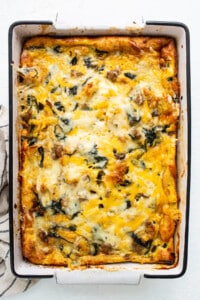 A casserole with spinach and cheese in a baking dish.