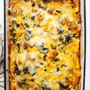 A casserole with spinach and cheese in a baking dish.