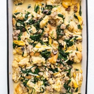 A casserole dish filled with spinach and mushrooms.