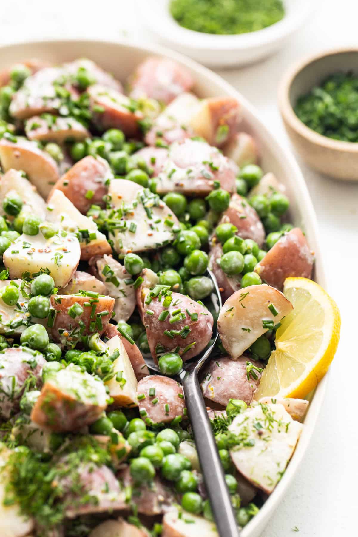 English pea and potato salad in a serving bowl.