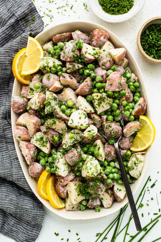 English pea and potato salad in a serving bowl.