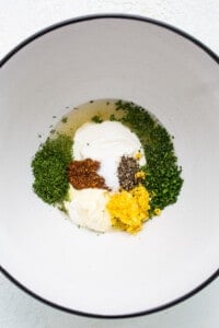 A white bowl with ingredients in it.