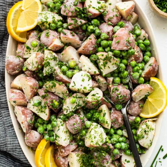 English pea and potato salad in a serving bowl.