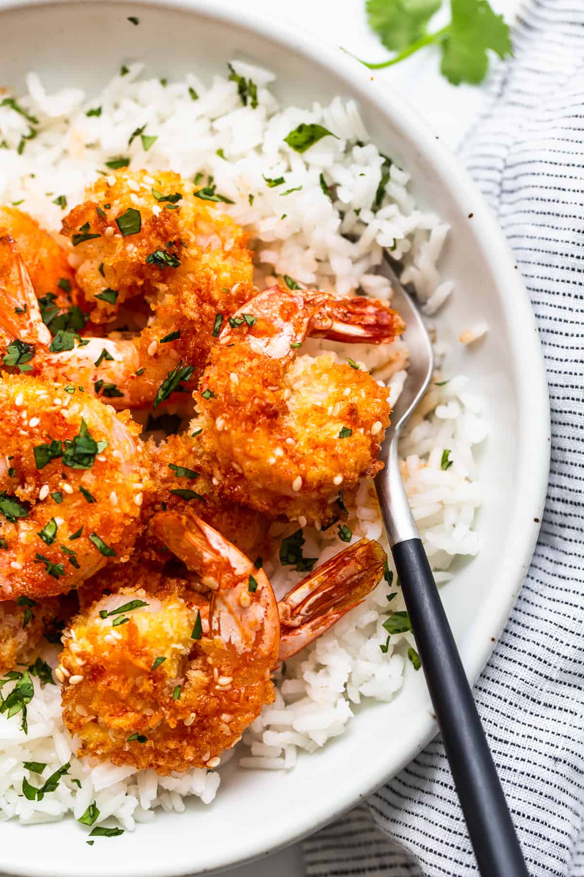 A bowl of shrimp and rice with a fork.