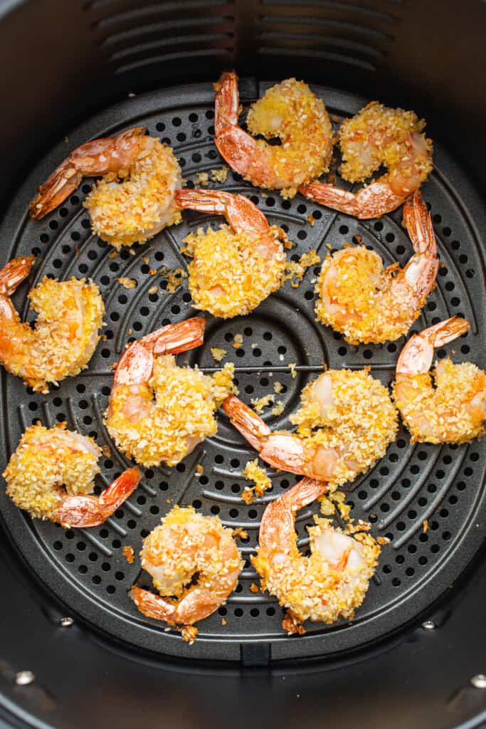 Fried shrimp in an air fryer with sesame seeds.