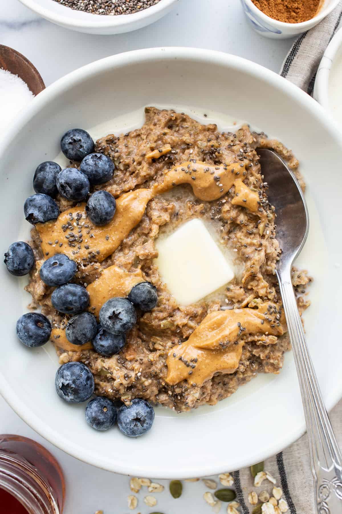 Porridge in a bowl topped with blueberries. 