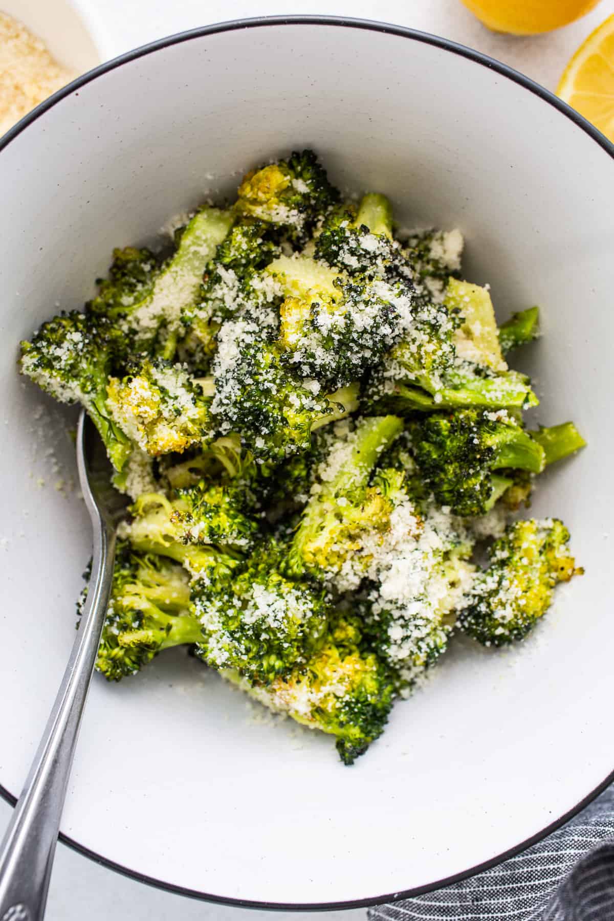 Roasted broccoli topped with parmesan cheese.