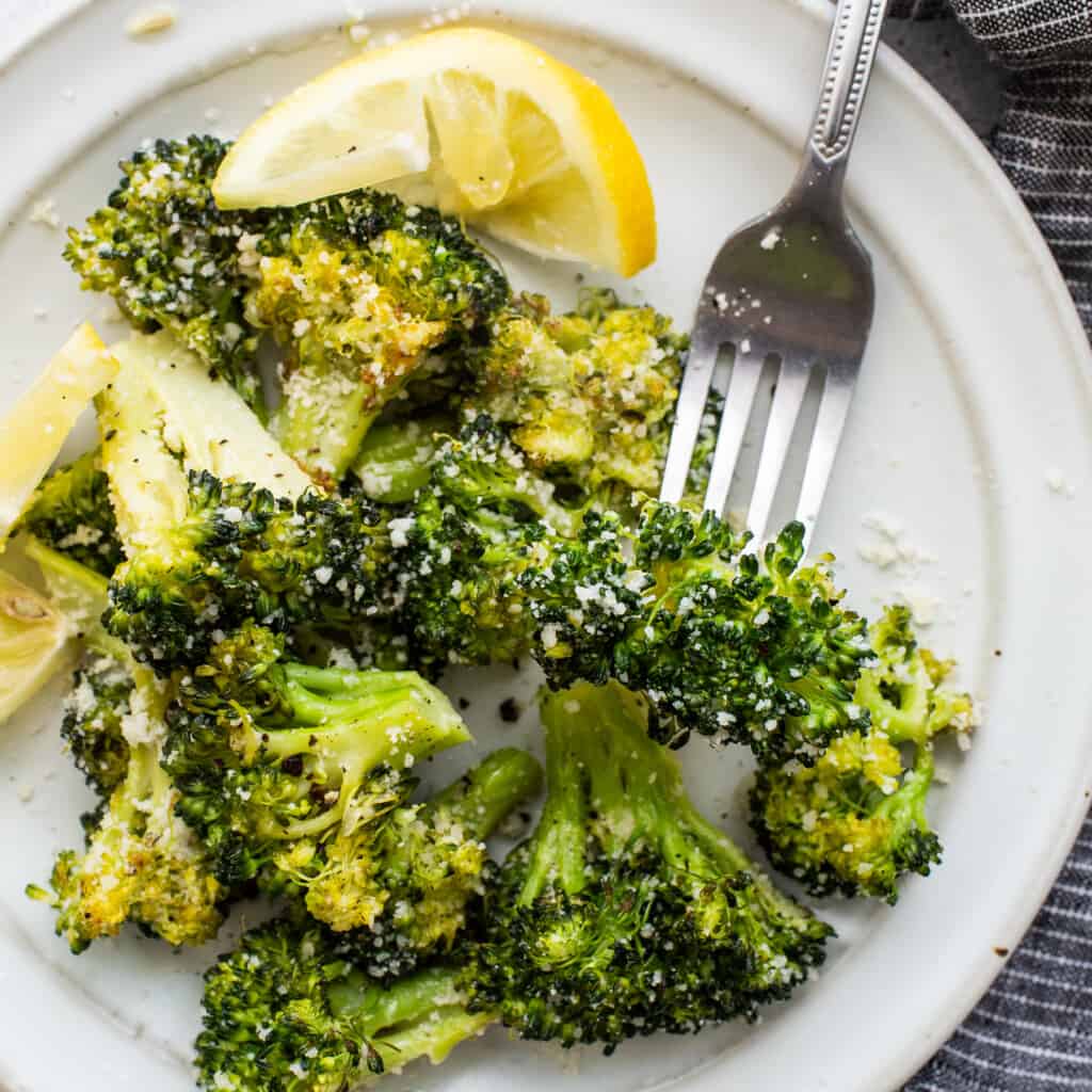 Roasted broccoli connected  a plate.