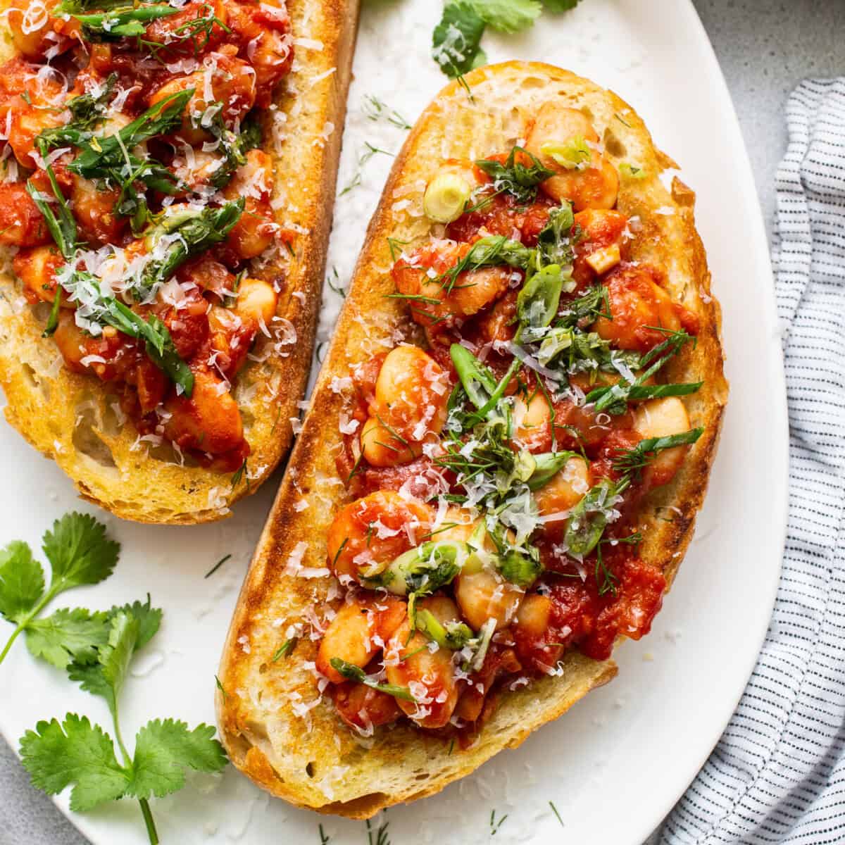 Chickpea and herb  bruschetta connected  a achromatic  plate.